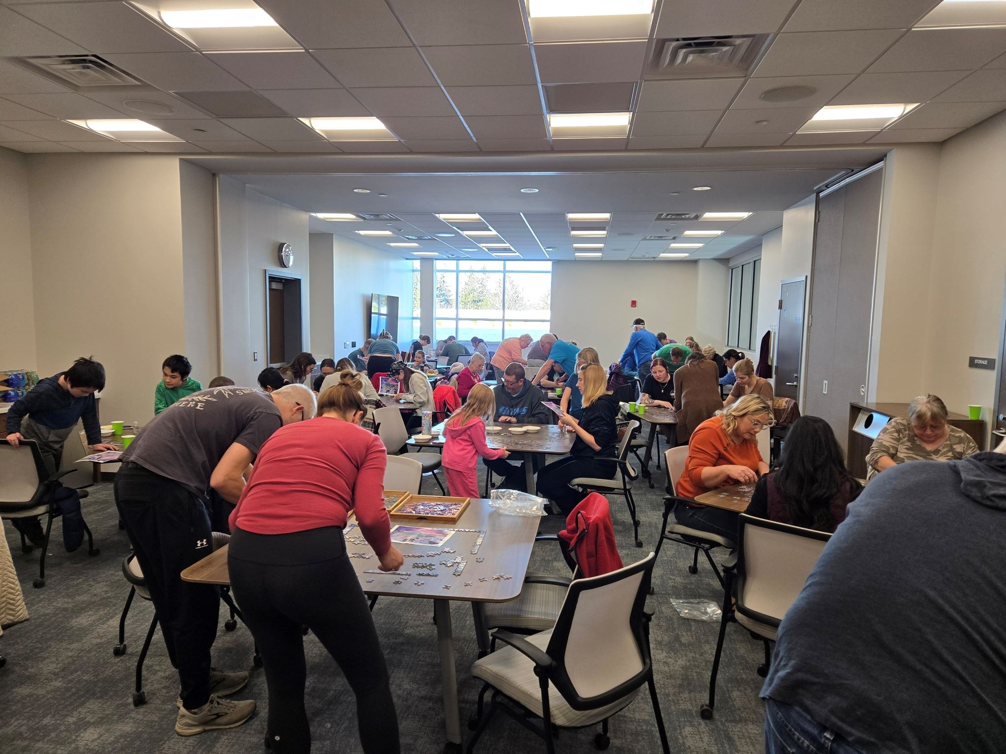 A room full of puzzlers at separate tables