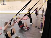 Seniors doing TRX in a gymnasium