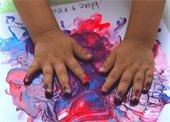 A child's hands fingerpainting