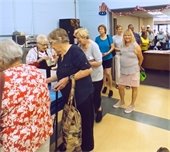 Seniors waiting in line to receive an ice cream sundae
