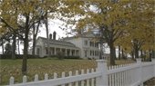 A Greenmead Historical Park building with fall foliage