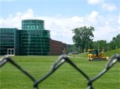 The Rec with a fence and a bulldozer in front of it