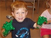 A child with green painted hands