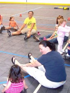 Parents Sitting and Playing Their Kids